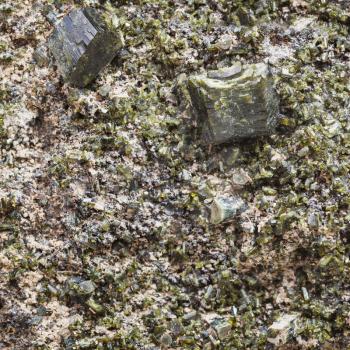 natural background - green epidote crystals on rock close up