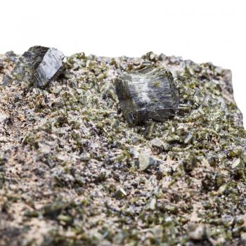 macro shooting of natural mineral stone - druse of green epidote crystals close up on rock isolated on white background