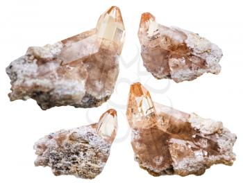 macro shooting of natural mineral stone - four topaz crystals on rocks isolated on white background