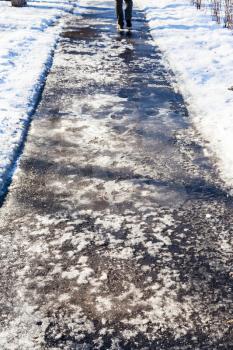 ice covered pedestrian path in sunny winter day
