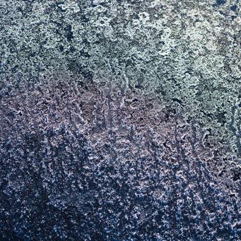 natural background - frost on black metal plate in winter