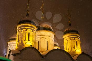 cupola of Church of the Trinity in Leaves on Sretenka street during snowfall in Moscow in winter night