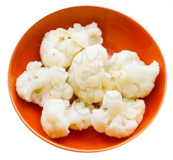 boiled cauliflower with butter in orange ceramic bowl isolated on white background
