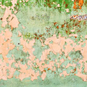 square background from peeling paint on wall of old wooden housel