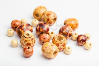 several painted natural wood beads close up