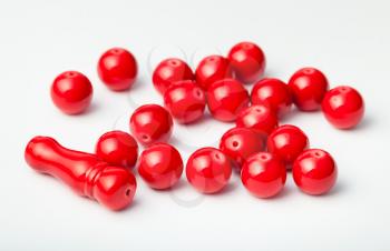 many red painted bone beads on white