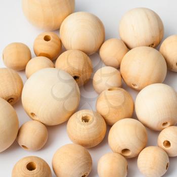 many natural wooden balls on white background