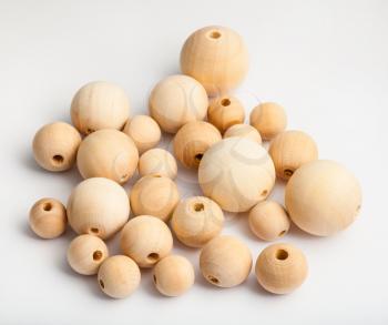 many natural wooden beads on white background