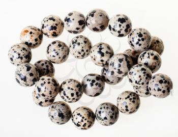 tangled necklace from aplite (dalmatian jasper) gemstone beads on white background