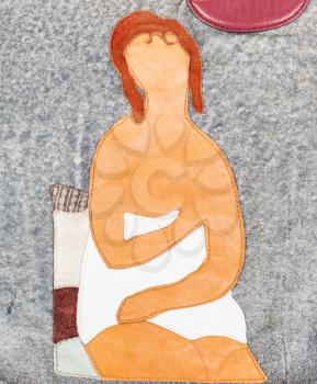 handmade leather applique - woman in towel sits on chair