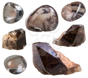 set of smoky quartz (Morion) crystals and polished gemstones isolated on white background