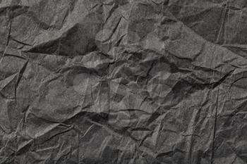 background from black colour crumpled paper
