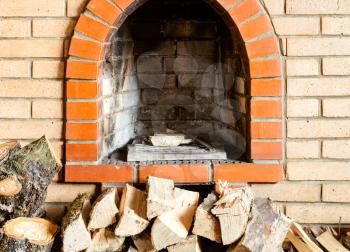 not kindled brick fireplace and firewoods indoor