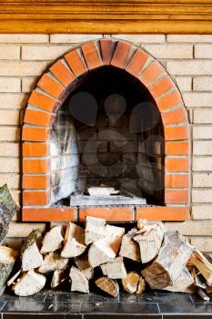 not kindled brick fireplace and wood logs indoor