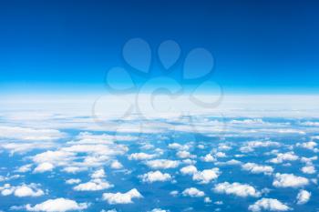 above view many little clouds in blue sky from aircraft