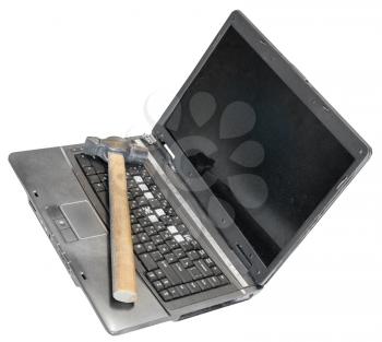 old defective laptop with hammer on keyboard isolated on white background