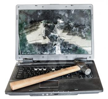 direct view of old broken laptop with hammer on keyboard isolated on white background