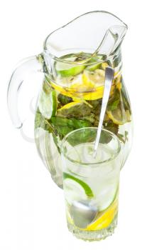 glass pitcher and tumbler with natural lemonade drink from lemon, lime, mint isolated on white background
