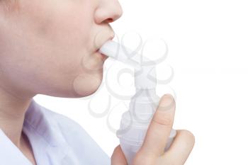 medical inhalation treatment - teen inhales with mouthpiece of modern jet nebulizer isolated on white background
