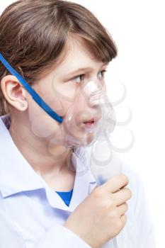 medical inhalation treatment - girl breathes with face mask of modern jet nebulizer isolated on white background