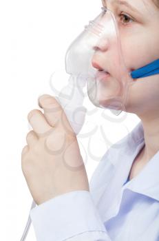 medical inhalation treatment - girl inhales with face mask of modern jet nebulizer isolated on white background