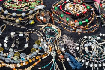 table with handmade necklaces from natural gemstones and jewelry at the fair