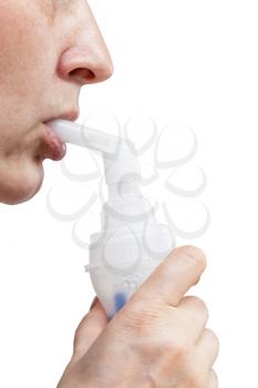 medical nebulization treatment - mouthpiece of modern jet nebuliser in lips of patient isolated on white background