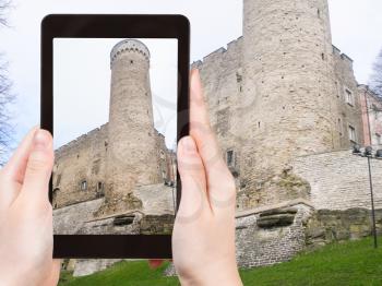 travel concept - tourist photographs tower of Toompea Castle in Tallinn city, Estonia (Toompea linnus) of on tablet pc