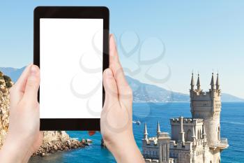 travel concept - tourist photographs on tablet pc with cut out screen with blank place for advertising