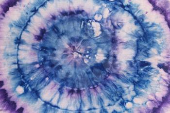 abstract pattern from blue and violet concentric circles on silk nodular batik