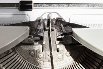 typebar types ink ribbon in old typewriter close up