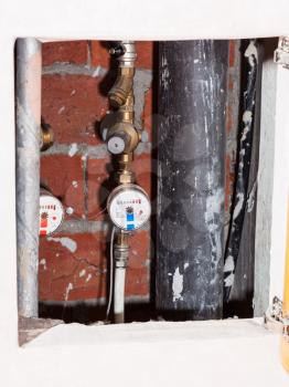 new residential water meters on pipes in niche
