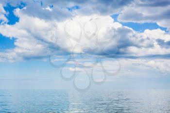 white clouds in blue sky over calm water of Azov Sea, Temryuk bay, Golubitskaya resort, Taman peninsula, Kuban, Russia
