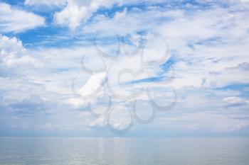 natural background - white clouds over calm blue water Sea of Azov, Temryuk bay, Golubitskaya resort, Taman peninsula, Kuban, Russia