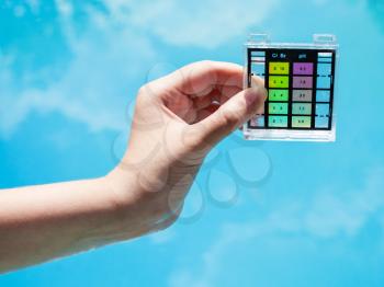 check water pollution in blue outdoor pool by chemical tester