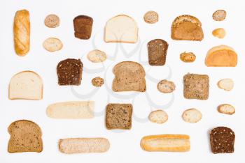 various sliced bread loaves and rolls on white background