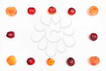 frame from ripe nectarines and peaches on white background