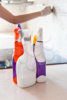 House cleaning - plastic bottles with detergents on kitchen tabletop