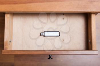 above view of one flash drive in open drawer of nightstand