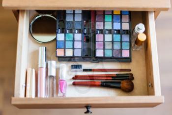 above view of cosmetic set in open drawer of nightstand