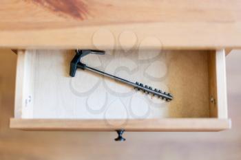 above view of long latchkey in open drawer of nightstand
