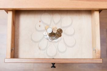 top view of russian coins in open drawer of nightstand