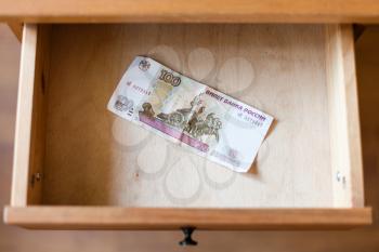above view of one hundred Russian rubles banknote in open drawer of nightstand