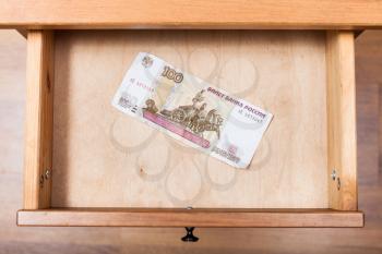 top view of one hundred Russian rubles banknote in open drawer of nightstand