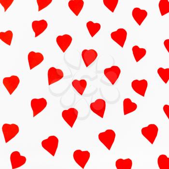 red hearts carved from paper on white background