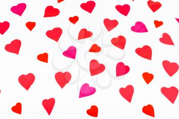 pink and red hearts cut out from paper on white background