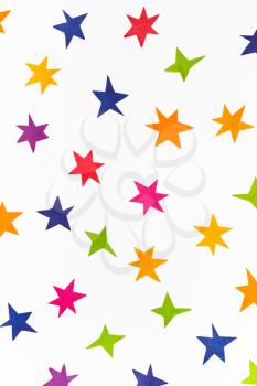 various stars cut out from colored paper on white background