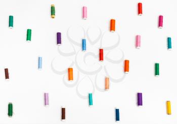 many spools of sewing thread on white background