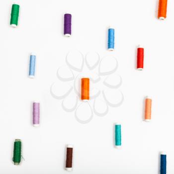 several spools of sewing thread on white background
