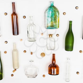several glass bottles and corks on white background